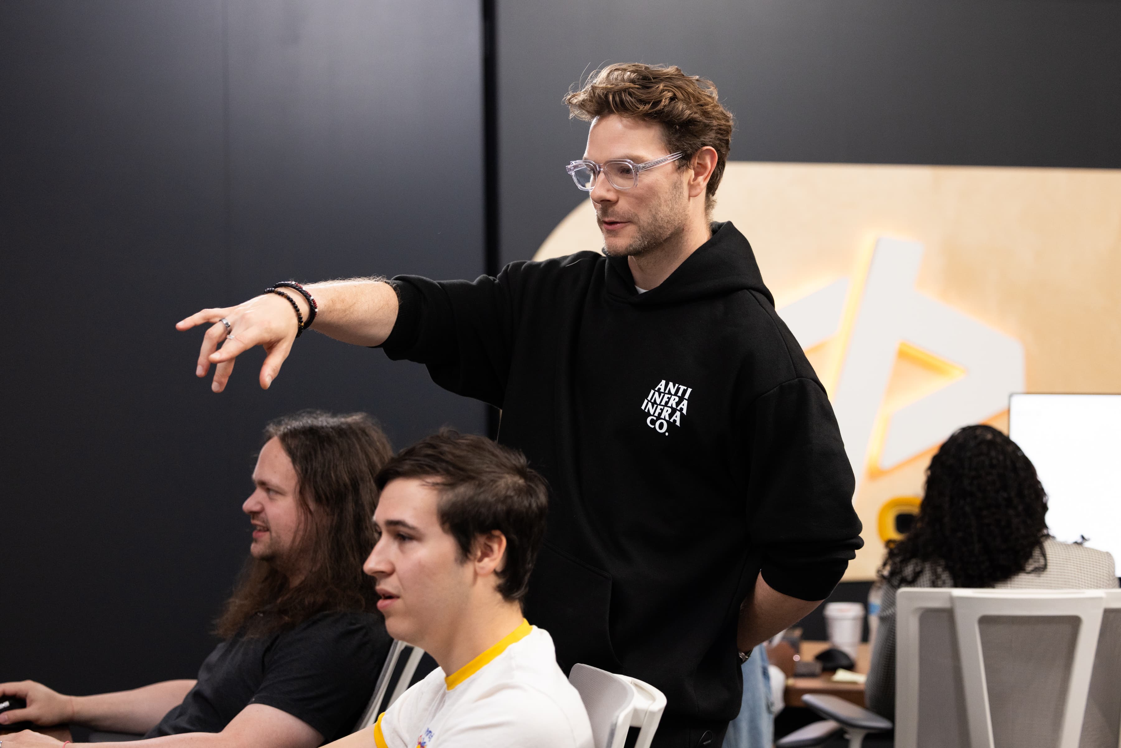 A contestant directing from behind the desks