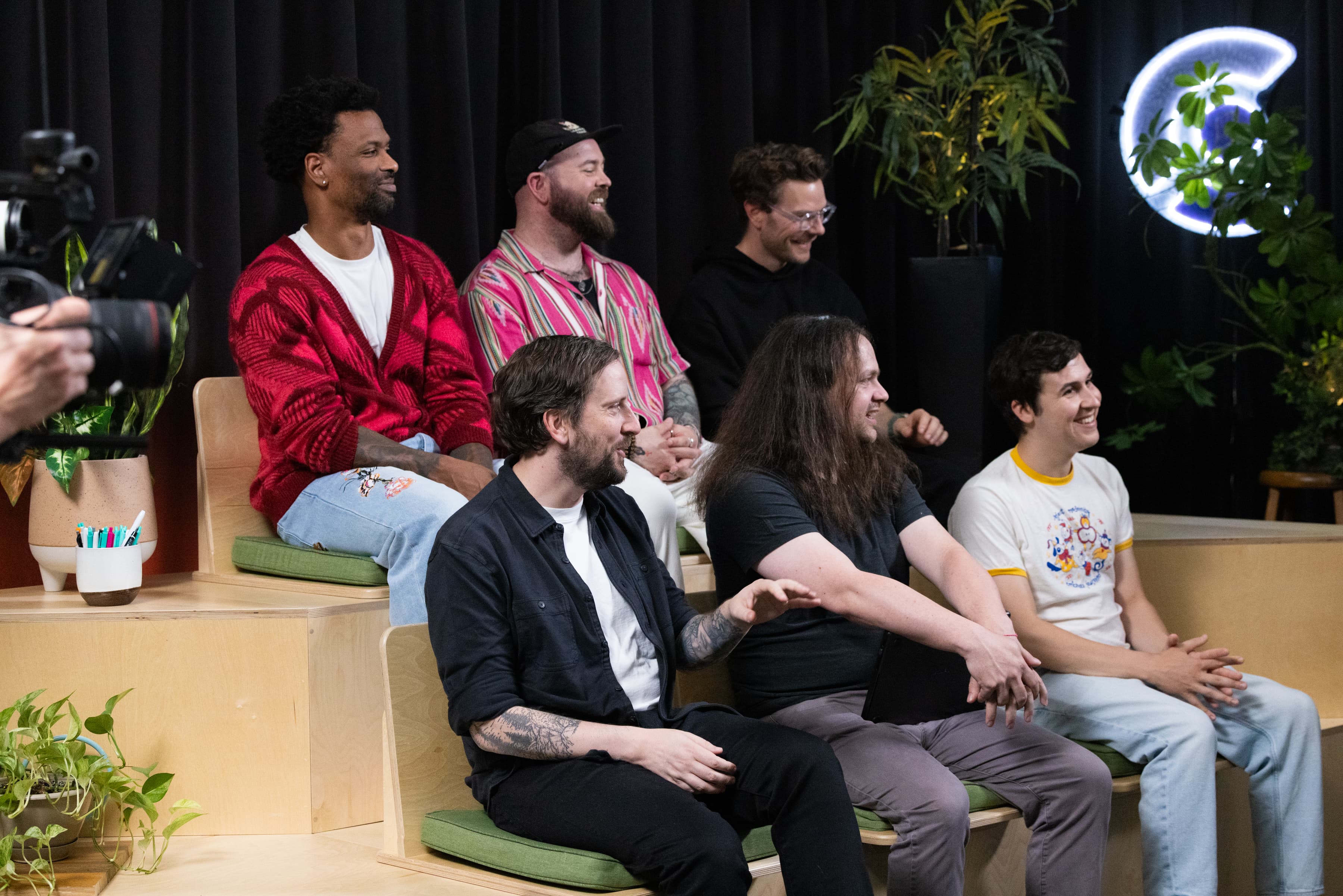 The teams on the bleachers mid-episode