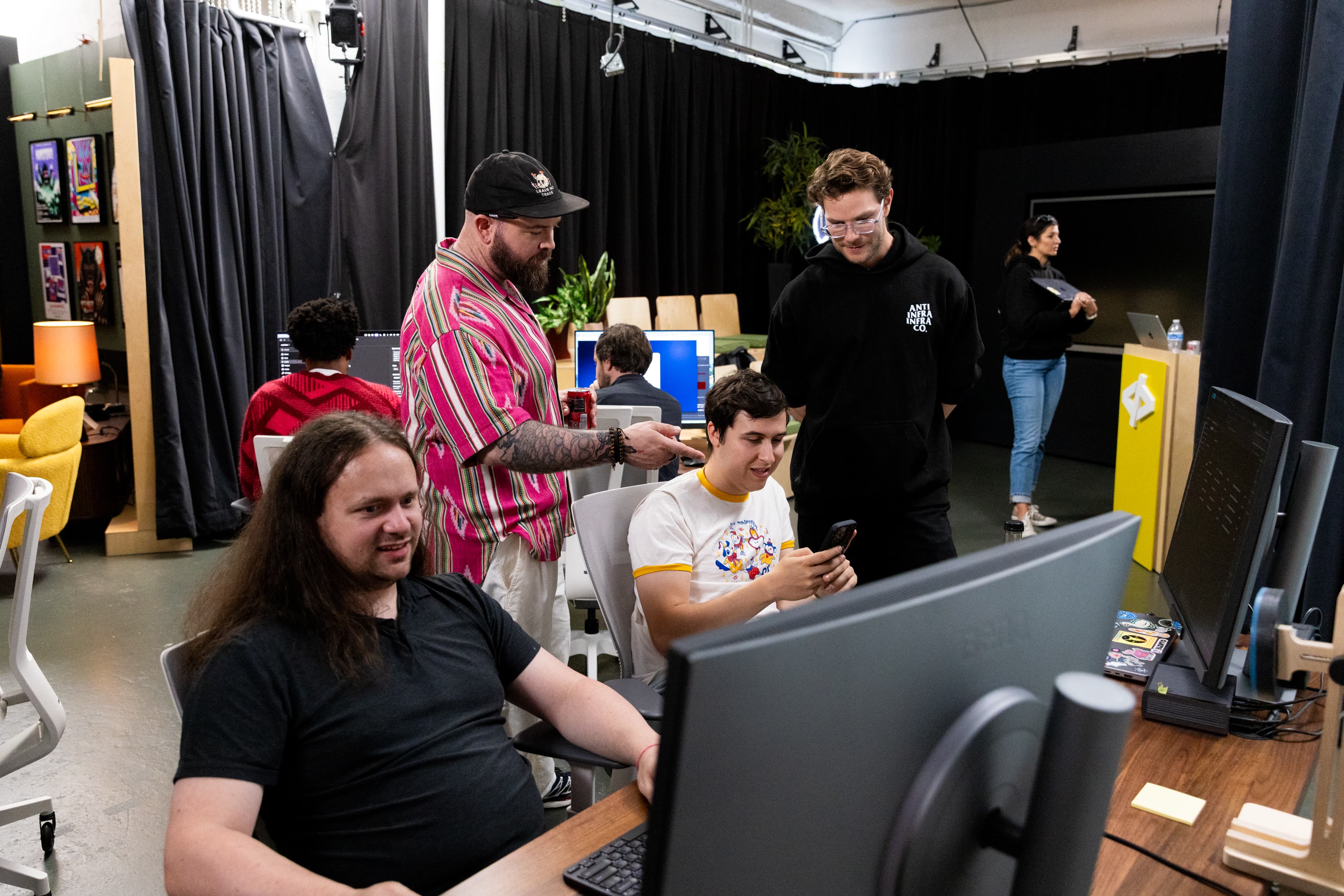 A huddle around a monitor during the challenge