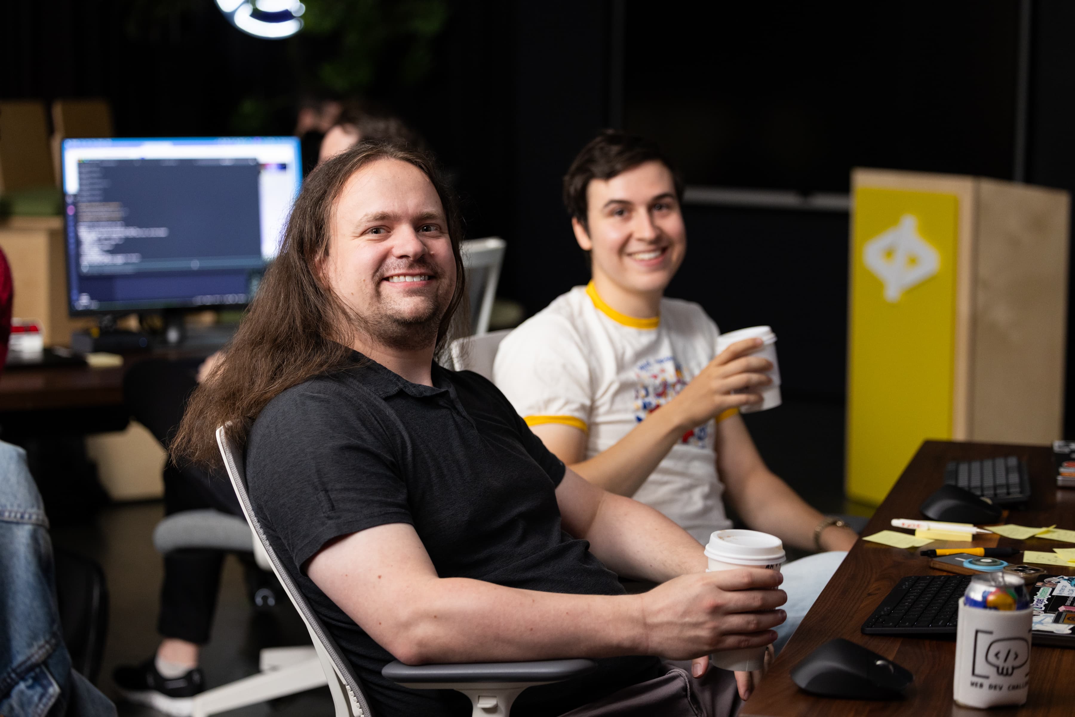 Two contestants taking a coffee break at the desk