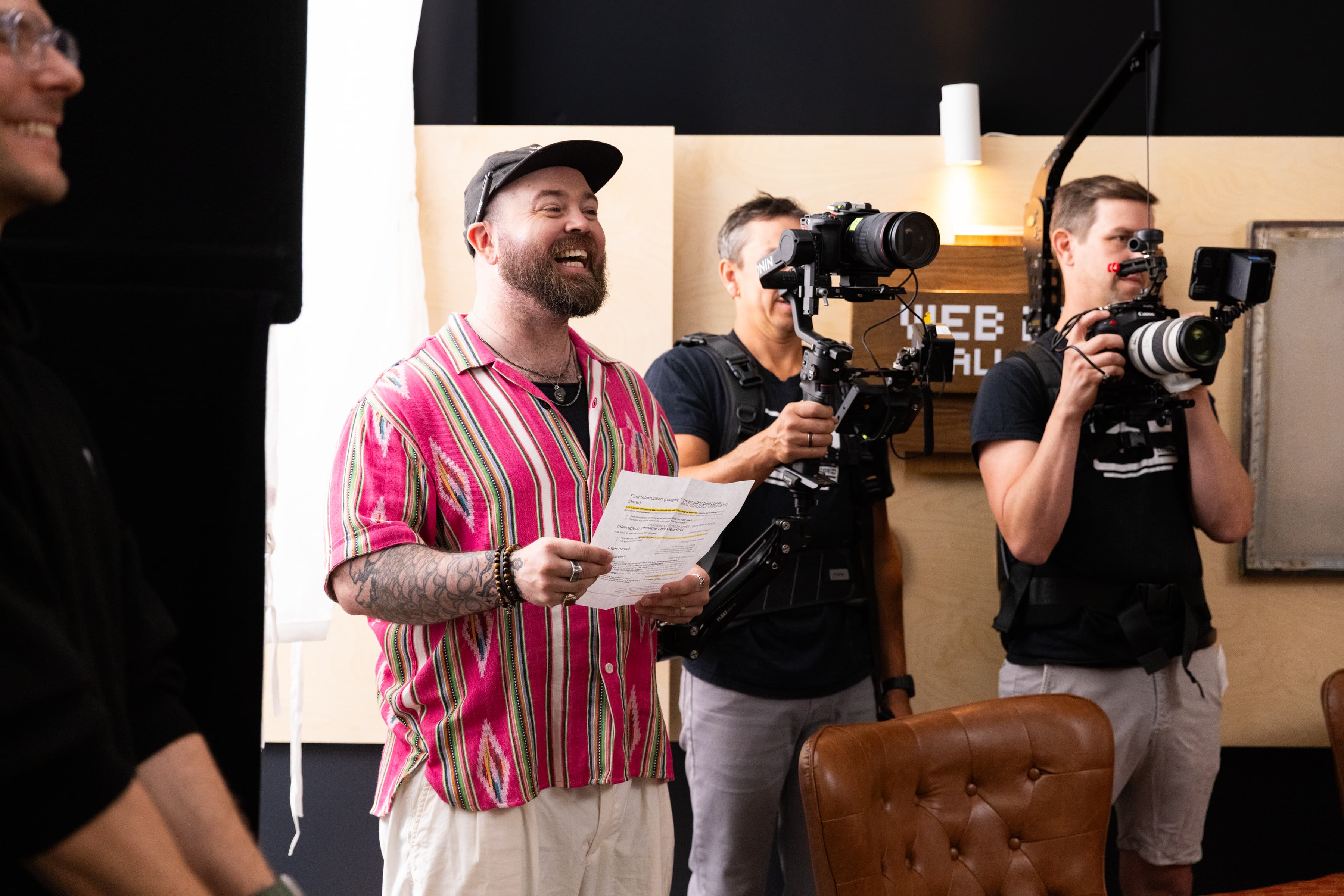 The host laughing on set while cameras roll