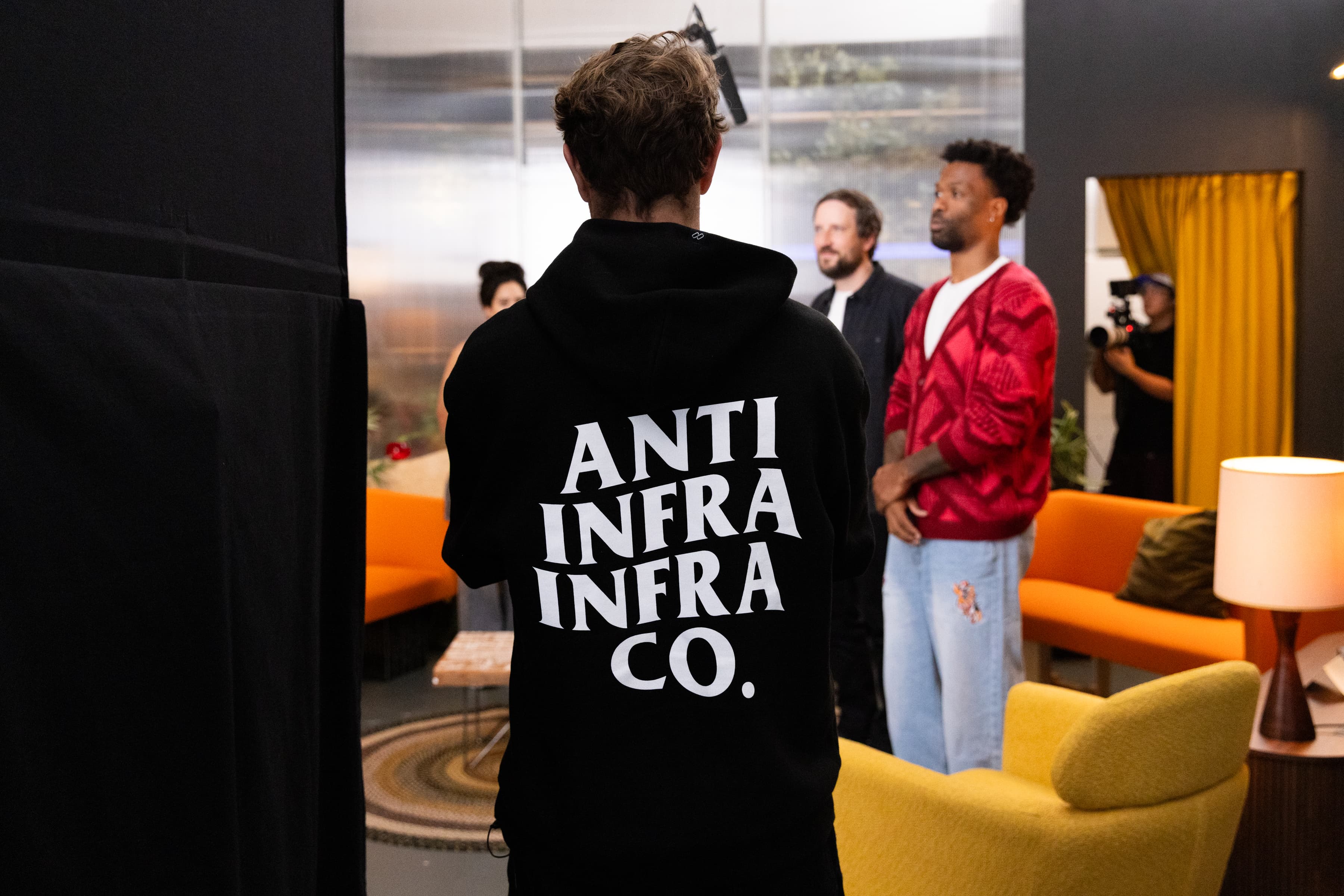 The Anti Infra hoodie on the CodeTV lounge set