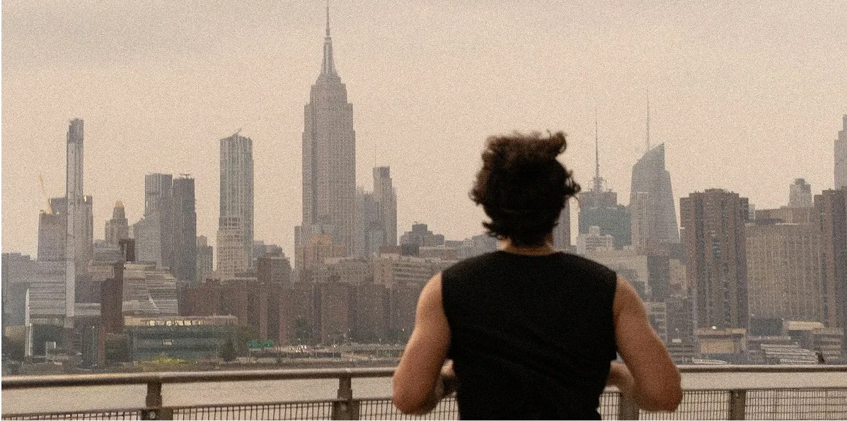 A runner on the waterfront, facing the Manhattan skyline.